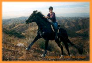 Natchez and Kathleen Kinmont crest the trail